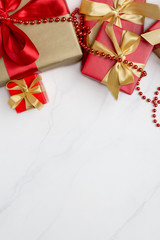 Festive red and gold gift boxes at white background top view