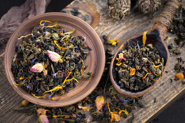 Dry tea leaves on a side background