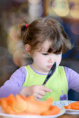 cute little girl eating melon
