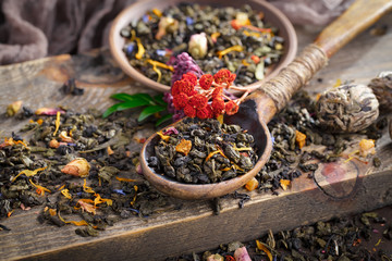 Dry tea leaves on a side background