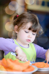 cute little girl eating melon