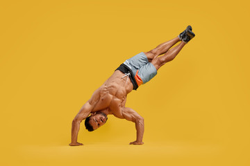 Athletic young man performing handstand stunt