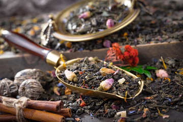 Dry tea leaves on a side background
