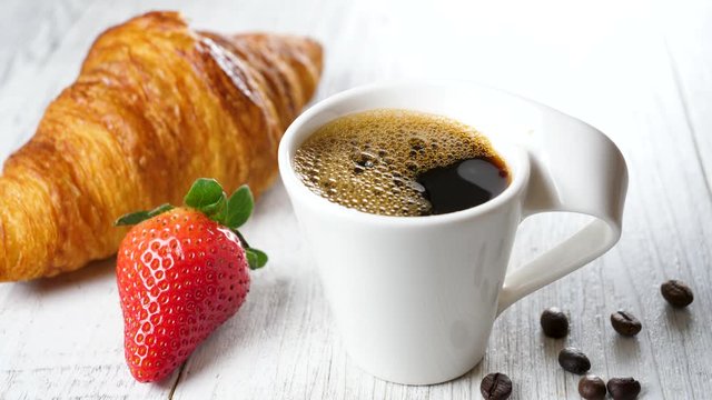 coffee cup with croissant and strawberry