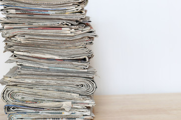Close up stacking of Newspaper on wooden table, global communications concept