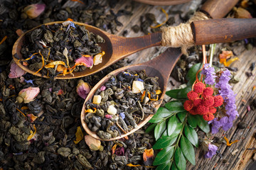 Dry tea leaves on a side background