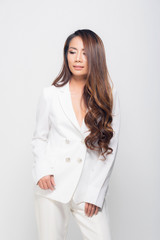 Fashion portrait woman wearing a white suit.