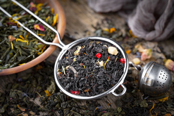 Dry tea leaves on a side background