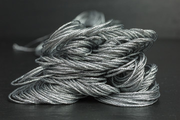 heap of skeins of silver embroidery threads