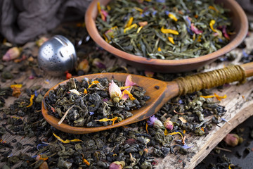 Dry tea leaves on a side background