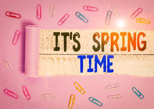 Handwriting text It S Spring Time. Conceptual photo Season After Winter Bloosoming of Flowers Transformation Paper clip and torn cardboard placed above a wooden classic table backdrop