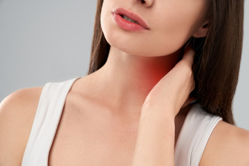 Woman showing pain in neck.