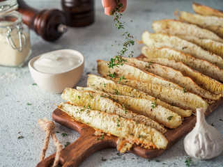 Baked Parmesan Garlic Zucchini. Thyme leaves fall on oven baked zucchini. Ideas and recipes for easy and healthy lunch or dinner