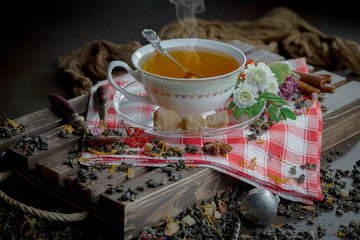 Tea hot drink on old background in composition on the table