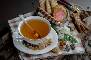 Tea hot drink on old background in composition on the table