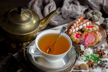 Tea hot drink on old background in composition on the table