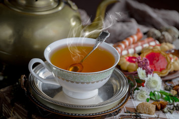 Tea hot drink on old background in composition on the table