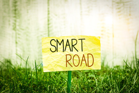 Handwriting text writing Smart Road. Conceptual photo number of different ways technologies are incorporated into roads Plain empty paper attached to a stick and placed in the green grassy land