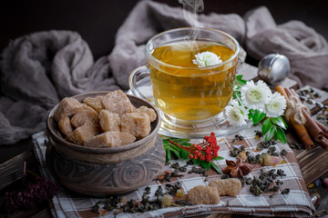 Hot tea in a cup on an old background.