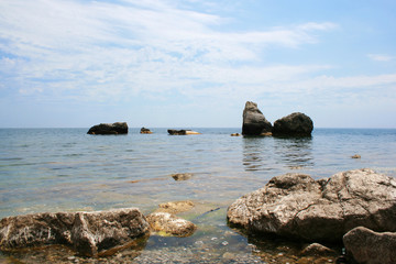 Fototapeta na wymiar Big stones in the water by the sea