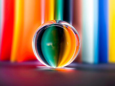 Rainbow colours reflected in a glass sphere