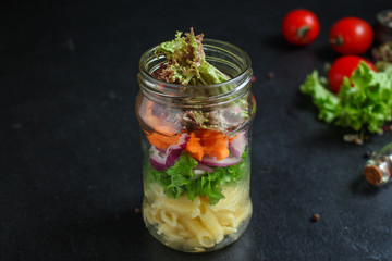healthy salad in a jar (vegetable snack pasta salad) menu concept. food background. top view. copy space