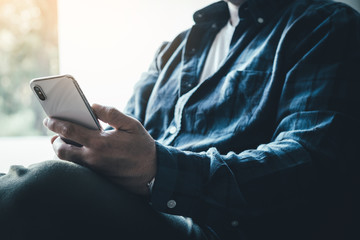 using cell phone.hand holding texting message on screen mobile chatting friend ,search internet information sitting in office.technology device contact communication connecting people concept