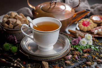 Tea hot drink on old background in composition on the table