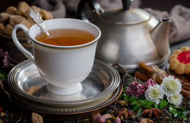 Tea hot drink on old background in composition on the table