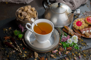 Tea hot drink on old background in composition on the table