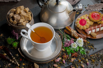 Tea hot drink on old background in composition on the table