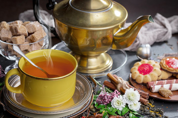 Tea hot drink on old background in composition on the table