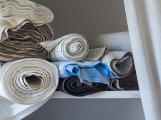 Rolls of linen on the shelf of the fabric store