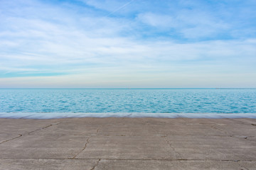 Fototapeta na wymiar Blue and Calm Lake Michigan off the Lakefront Trail in Chicago