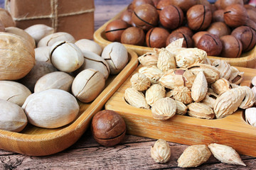 Mix of nuts on a wooden plate