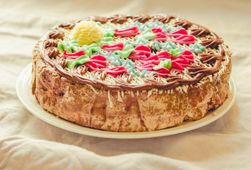 Traditional Kiev(Kyiv) cake or daquoise meringue a piece of cake with butter cream on plate. Tasty holiday cake on a comfort linen white background.