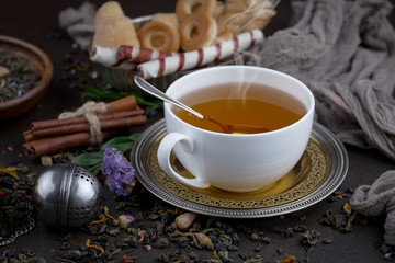 Tea hot drink on old background in composition on the table