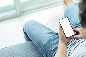 Mockup image blank white screen cell phone.man hand holding texting using mobile on desk at coffee shop.background empty space for advertise text.people contact marketing business,technology 
