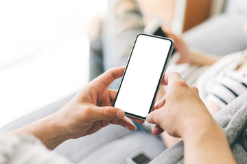 Mockup image blank white screen cell phone.man hand holding texting using mobile on desk at coffee shop.background empty space for advertise text.people contact marketing business,technology 