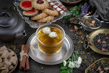Tea hot drink on old background in composition on the table