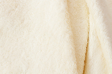 Bath towel closeup background. Texture of fluffy white towels. Template blank copy space and mock up. Summer accessory for swimming pool. Bath and spa hygiene. Selective focus.