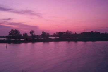 Fototapeta na wymiar Purple and pink twilight over the lake