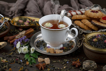 Tea hot drink on old background in composition on the table