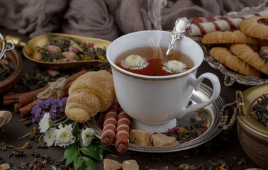 Tea hot drink on old background in composition on the table