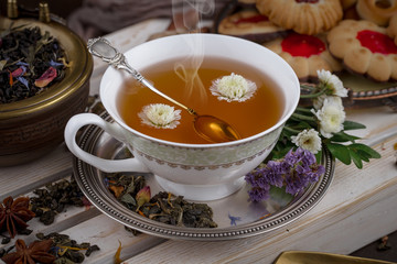 Tea hot drink on old background in composition on the table