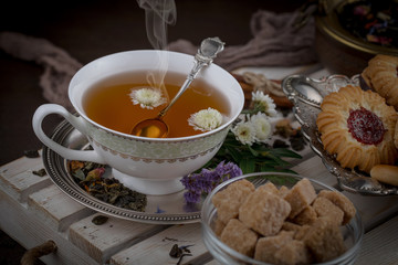 Tea hot drink on old background in composition on the table