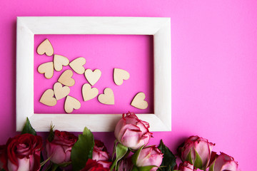 White frame with hearts on a pink background. Valentine's day concept, wedding, love