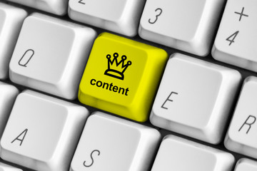 Yellow content is king key on the white computer keyboard.