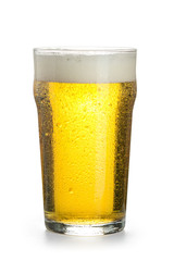 Light cold beer in a nonic-pint glass with foam, bubbles and condensation droplets isolated on a white background.