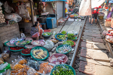 MAEKLONG, THAILAND - DECEMBER 15, 2019: The famous railway markets at Maeklong. Four times a day the train runs through these stalls